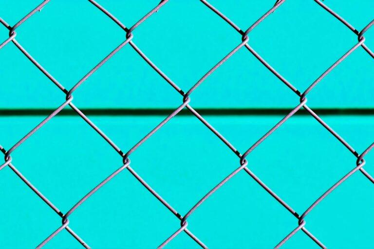 blue metal fence with chain link fence