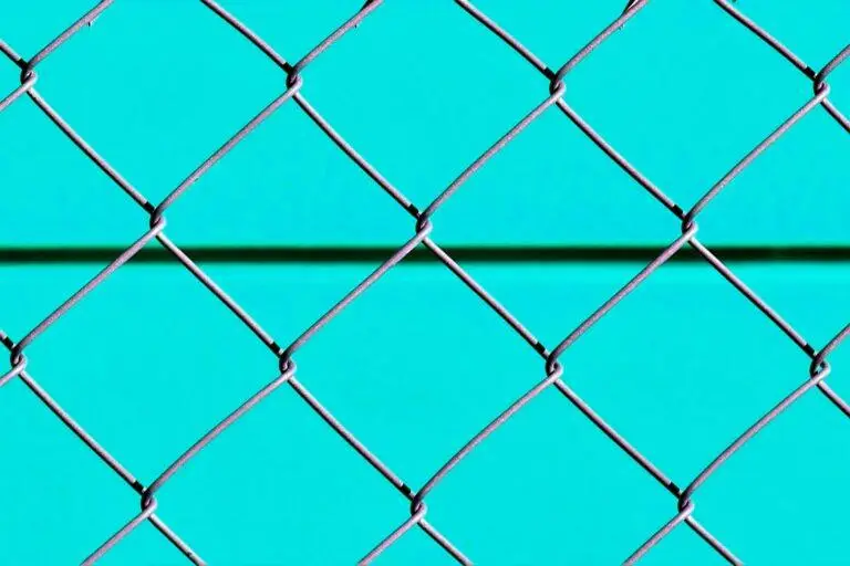 blue metal fence with chain link fence