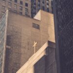 low angle photography of concrete building with cross